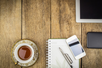 Wooden table with office supplies, top view
