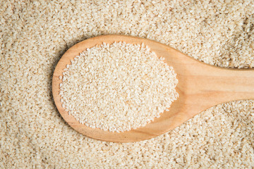 scoop of sesame on a pile of sesame