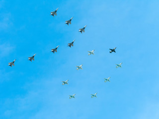 Number 70 made by 7 Mig-29 and 8 Su-25 on blue sky background
