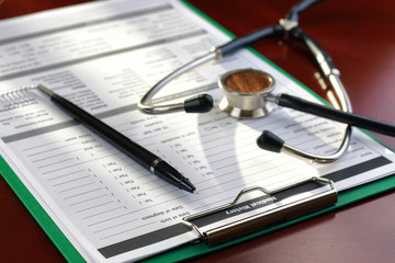stethoscope medical documents pen