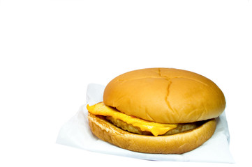 Pork cheese burgers and french fries in a red box on a white bac