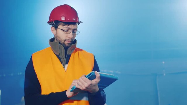 Builder works with the tablet, blurred blue background