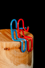 Colorful paperclips on black background