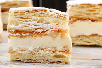Puff pastry cake on wooden background