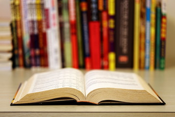 Old Book with Open Pages Left on Study Table with Blurry Background