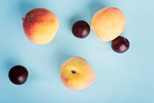 Ripe Peaches And Plums On The Blue Background