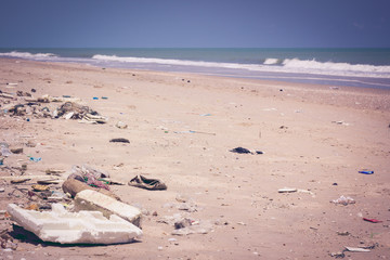 Pollution on the beach of tropical sea. Outdoors. Vintage style.