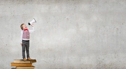 Kid boy with megaphone