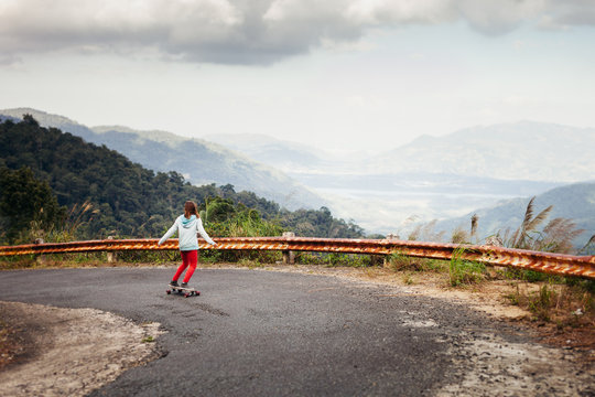 girl skateboarding in tropical jungle mountains travelling asia