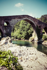 Fototapeta na wymiar Old Roman stone bridge in Cangas de Onis (Asturias), Spain
