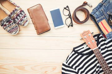 Casual apparel and accessories on a background of wood.