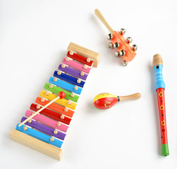 Musical instruments collection on old wooden table background. Top view