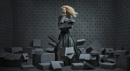 Conceptual picture of a blond lady among a lot of boxes