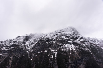 Mountain peak draped in clouds an overcast day