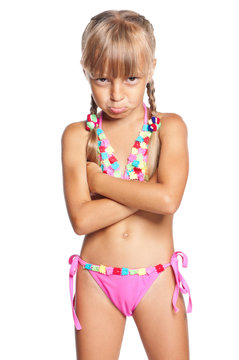 Unhappy little girl in swimsuit