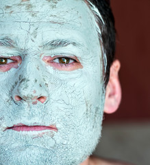 Mask of blue clay on men face