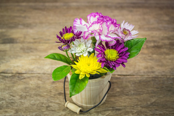 A bouquet of flowers on a wooden floor blank.