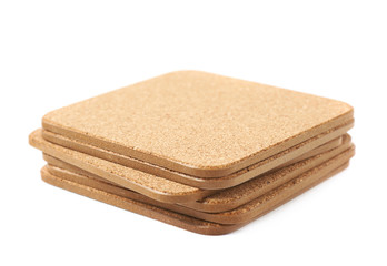 Pile of cork textured coasters isolated