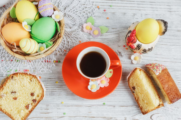 Table setting for Easter - Easter cakes, coffee cup and colored