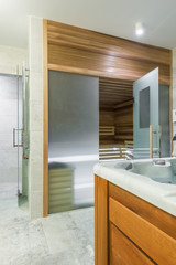 Interior of corner of bathroom with wooden sauna