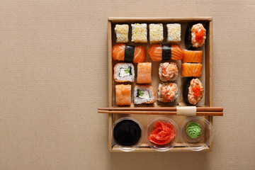 Set of sushi rolls at carton texture background 