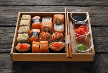 Set of sushi maki and rolls at black rustic wood. © Prostock-studio