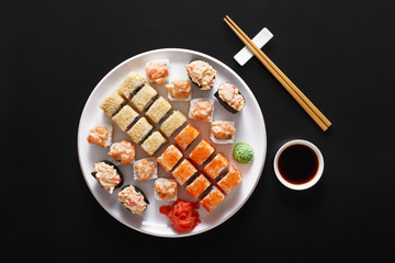 Set of sushi maki and rolls at black rustic wood. © Prostock-studio