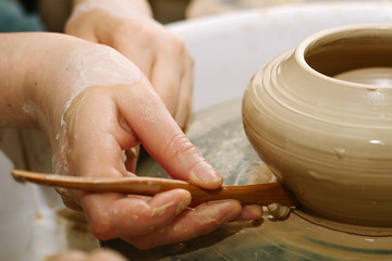 pottery. the teacher teaches the student work on the potter's wheel