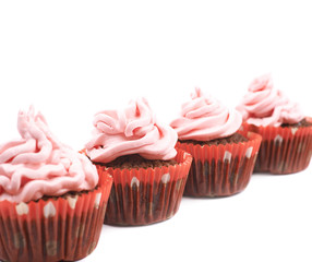 Chocolate muffin with pink cream isolated