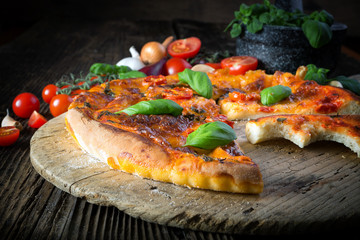 homemade pizza margherita with mozzarella, basil and tomatoes