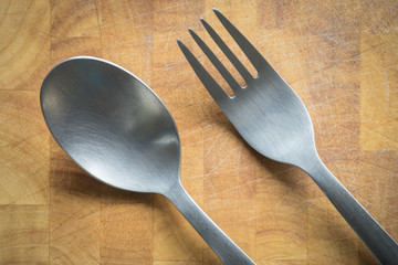 fork and spoon on wooden background