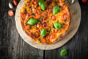 homemade pizza margherita with mozzarella, basil and tomatoes