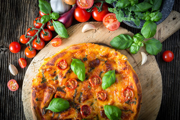 homemade pizza margherita with mozzarella, basil and tomatoes