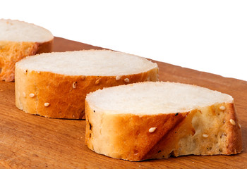 Delicious fresh bread sliced on a wooden board