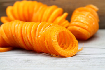 Carrot sprialized / Spiralized carrot on a wooden background.