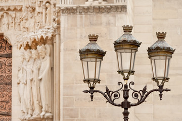 Fototapeta na wymiar Street light pole seen near Notre Dame Cathedral in Paris, France