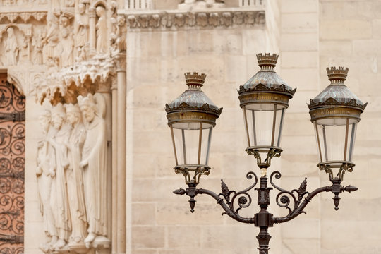 Fototapeta Street light pole seen near Notre Dame Cathedral in Paris, France
