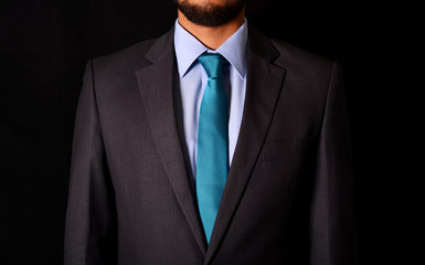 closeup businessman suit on black background