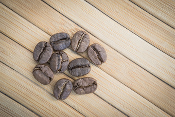 fresh roasted coffee beens on a wooden surface, selective focus