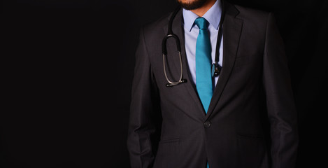 Doctor with stethoscope around neck black background