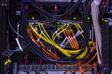 rear of the device with lots of computer cables and patch cords