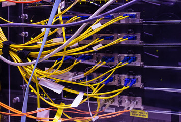 rear of the device with lots of computer cables and patch cords