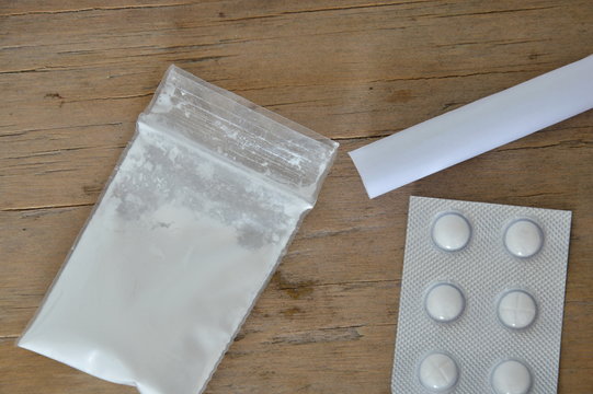 cocaine in resealable bag and drug blister with roll paper