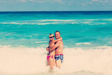 Young romantic couple laying on sandy beach