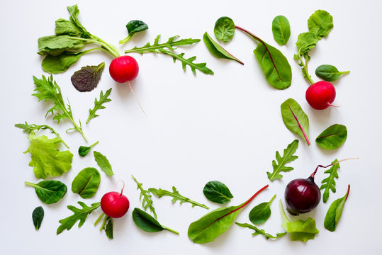 Salad leaves and radishes background