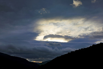 juicy sunset in the sky over the mountains