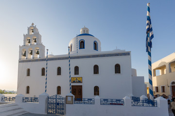 White Orthodox church in town of Oia, Santorini island, Thira, Cyclades, Greece