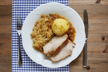 German roast pork with raspeball and sauerkraut 