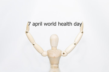 Hand writing 7 april World health day with wooden persona on transparent wipe board.