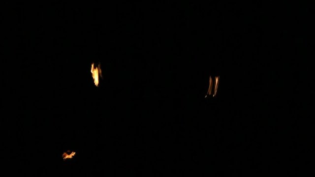 Performers are spinning torches while performing a fire show at night celebrating the international Earth hour event in Sofia.